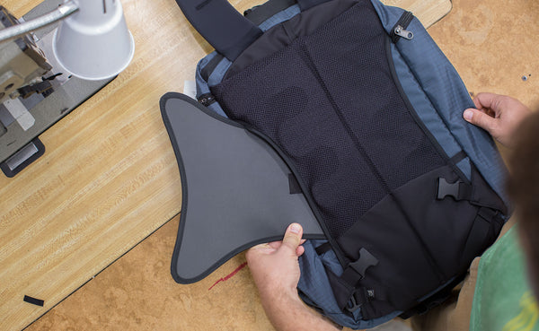Person adding the optional Techonaut internal frame to the Techonaut.